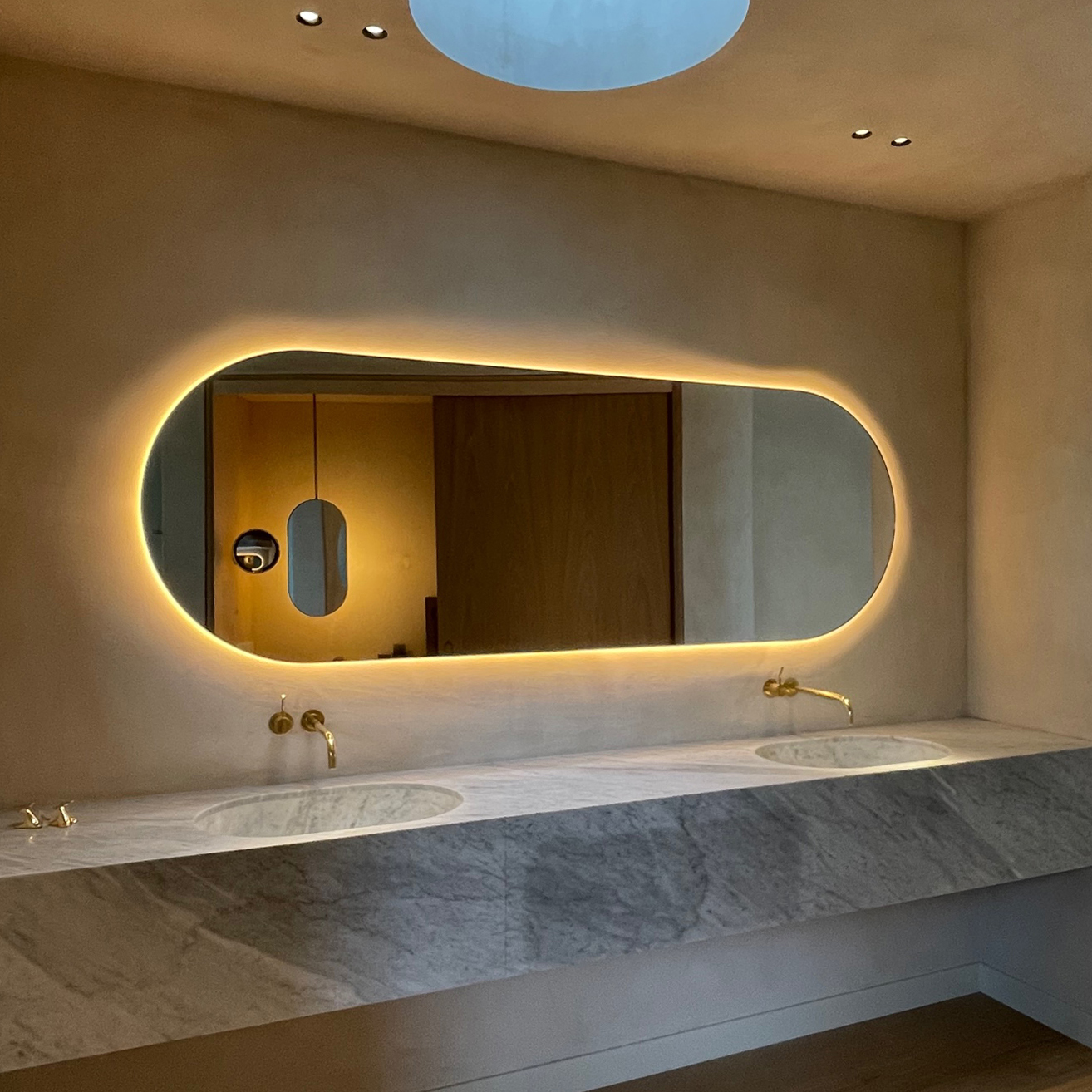 Oversized Capsula™ mirror with back illumination for Susana Michaelis Design