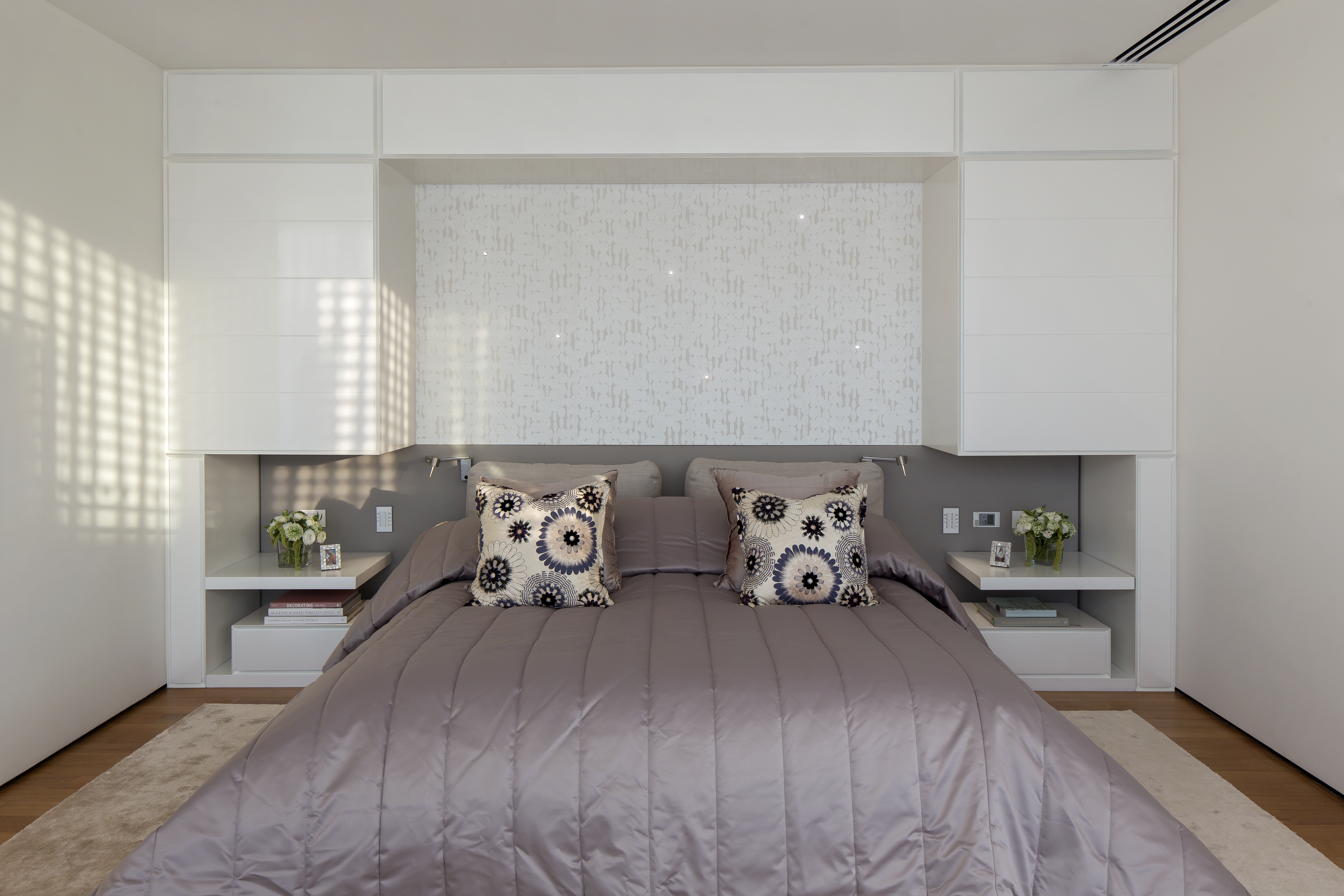 Bespoke bedroom cabinets and upholstery with specalist pearlised laquer paint to reflect the brightness of the sun. Details of Swarovski lights with in the wallpaper