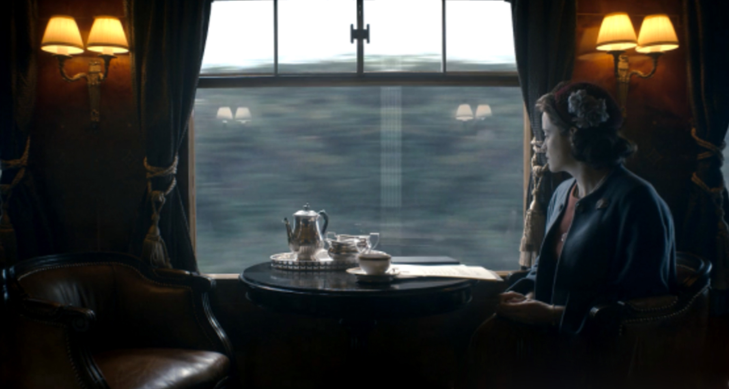 The train scene with the Queen on the set of The Crown featuring gathered silk wall lampshades 