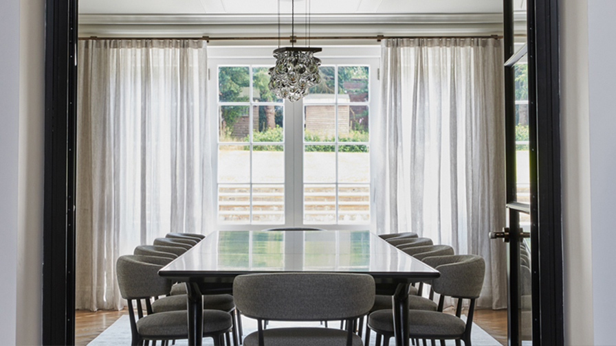 Contemporary dining room with VENESTRE bespoke sheer curtains, fitted to large windows and French doors. 