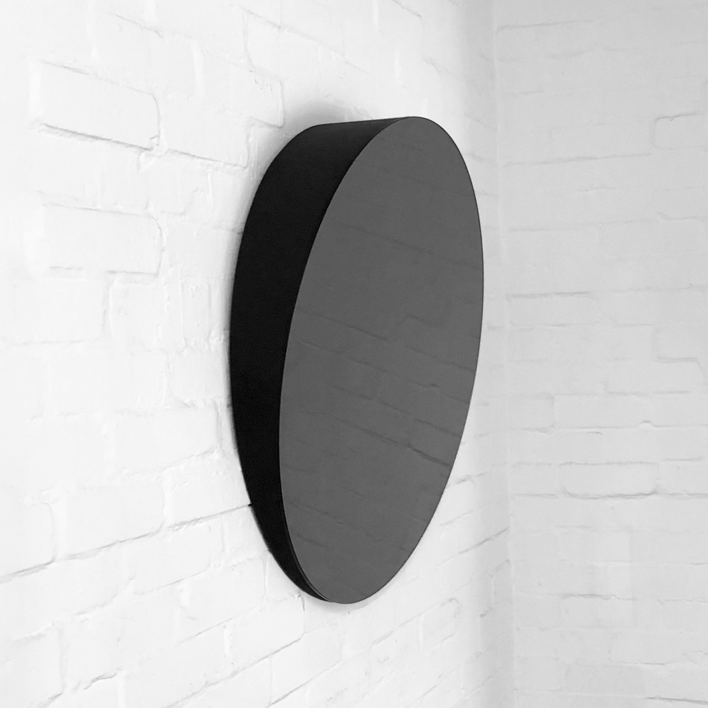 Orbis™ Accessible Black Tinted Bathroom Mirror Tilted at a 10 Degree Angle