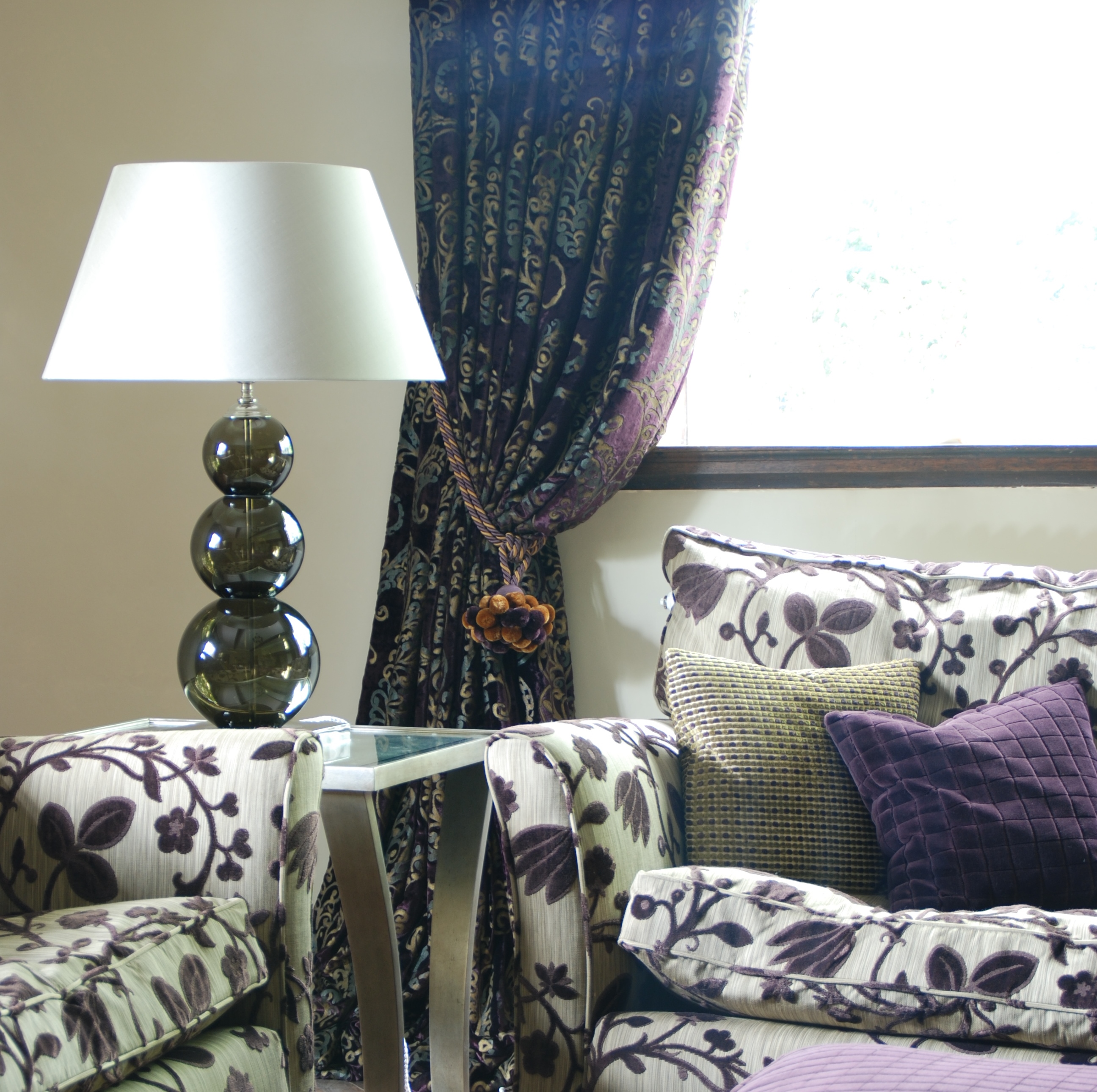 Patterned Sofas with Purple curtains