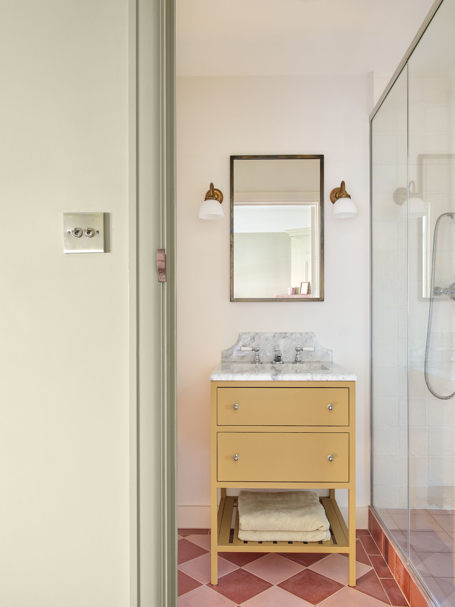 Emerie and Cie pink chequerboard floor tiles with yellow bathroom vanity