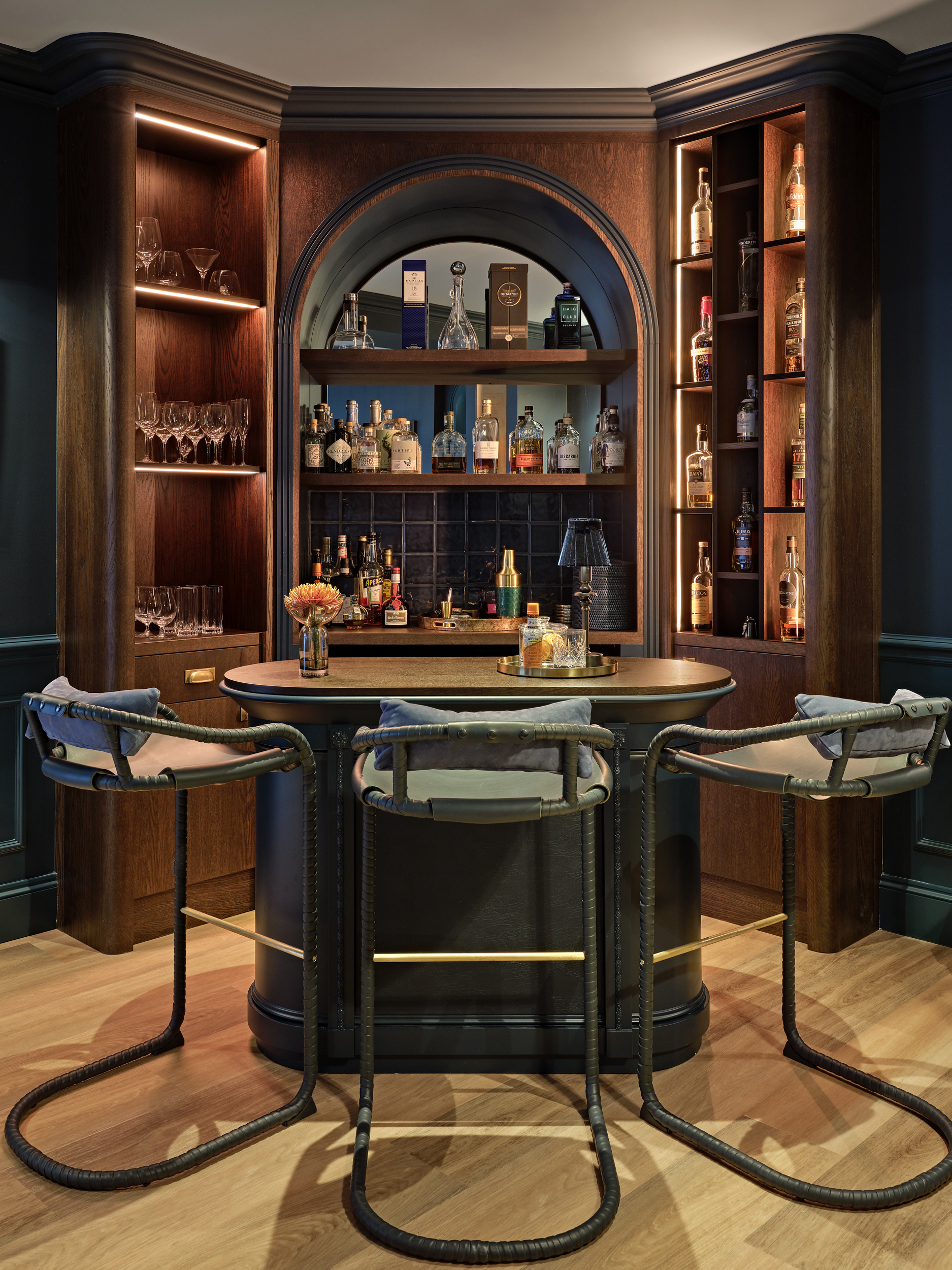 Bespoke home bar with stained oak, leather panels, LED lighting  and antique mirror .