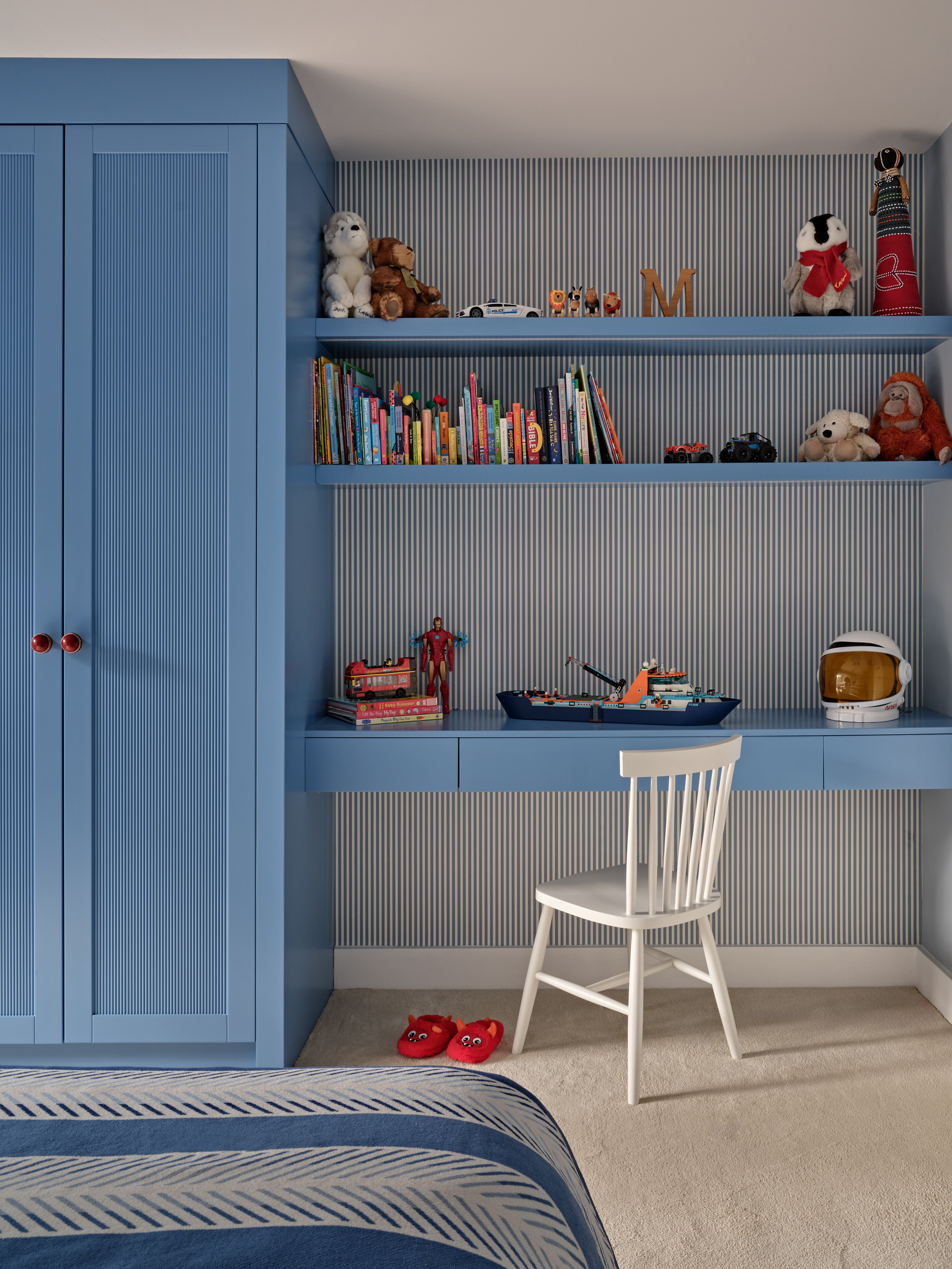 Children's bedroom. Bespoke blue wardrobe and integrated desk and shelving. 