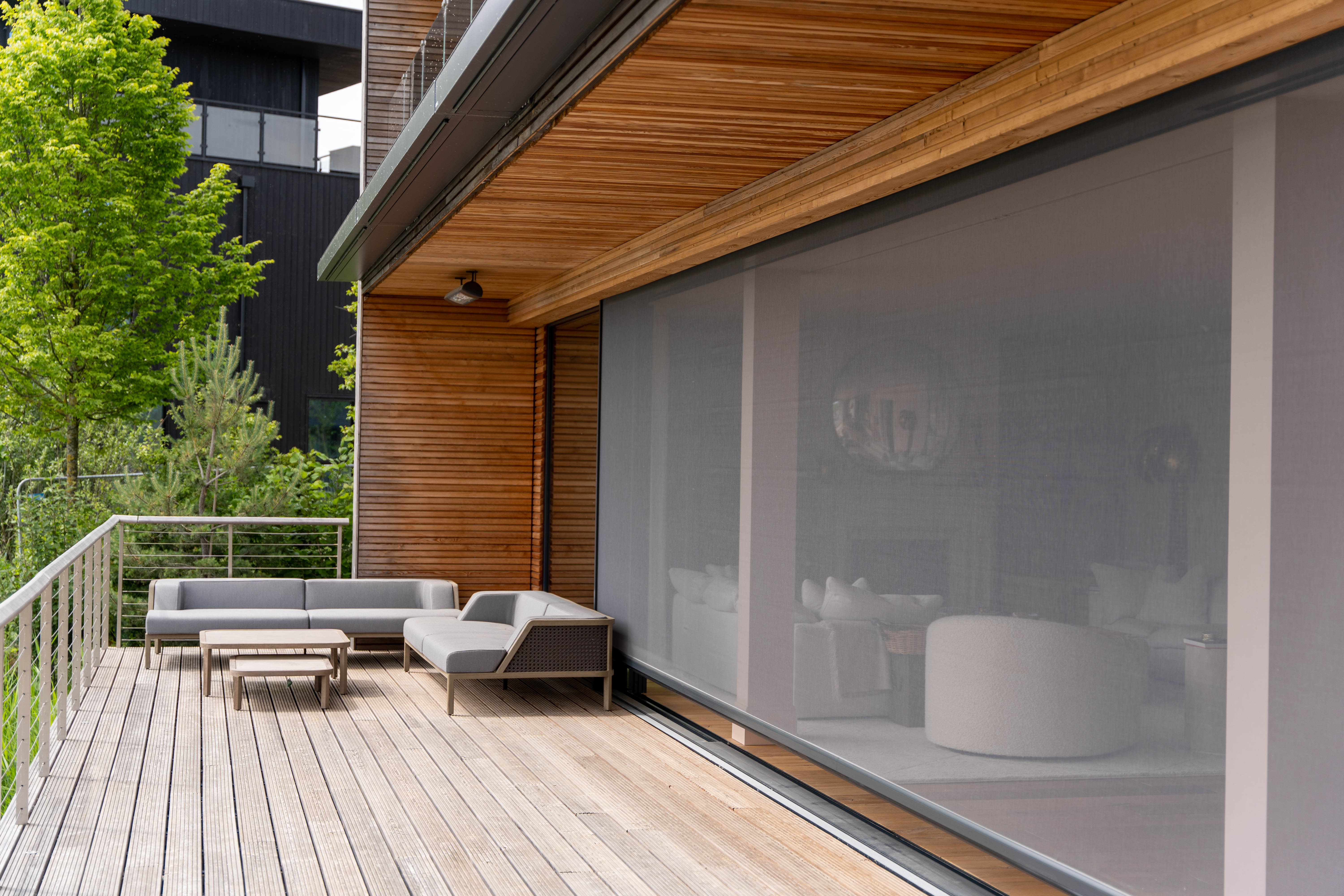 Automated power screen keeping flies out of lakeside lodge