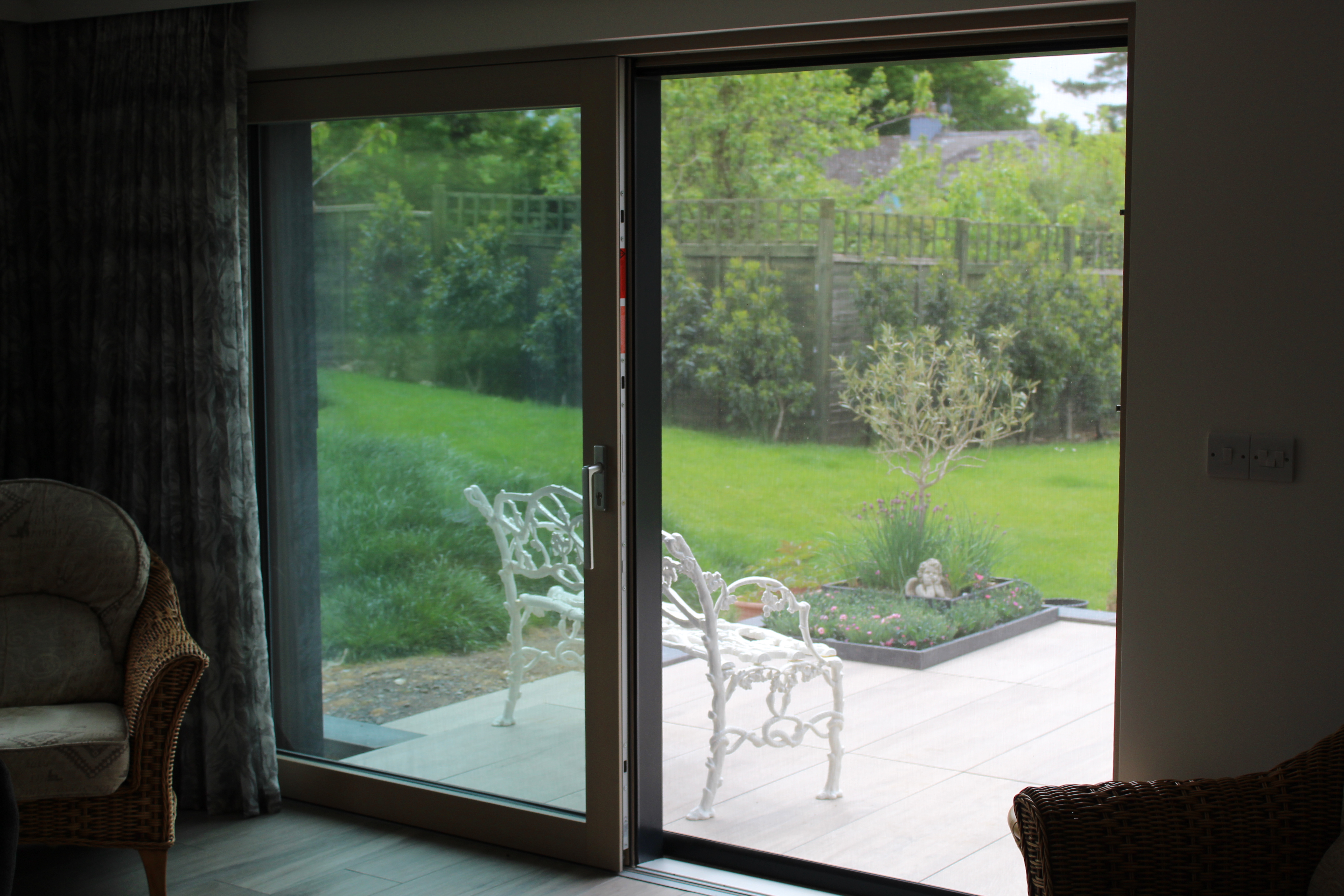 Solar screens custom-installed on windows of a Passive House, contributing to energy savings and comfort