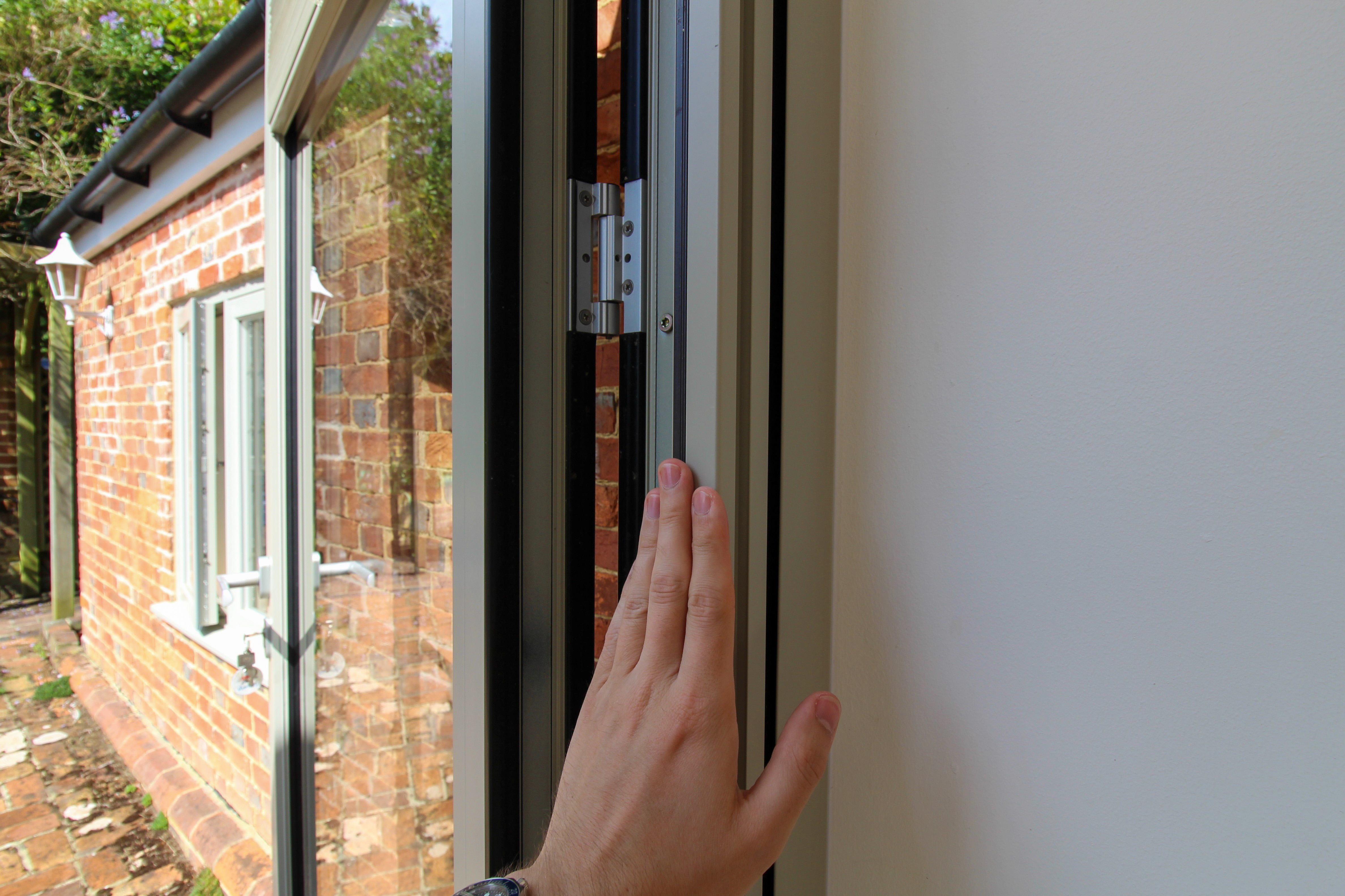 The pleated screen’s slim, low-profile design maintaining unobstructed views of the garden