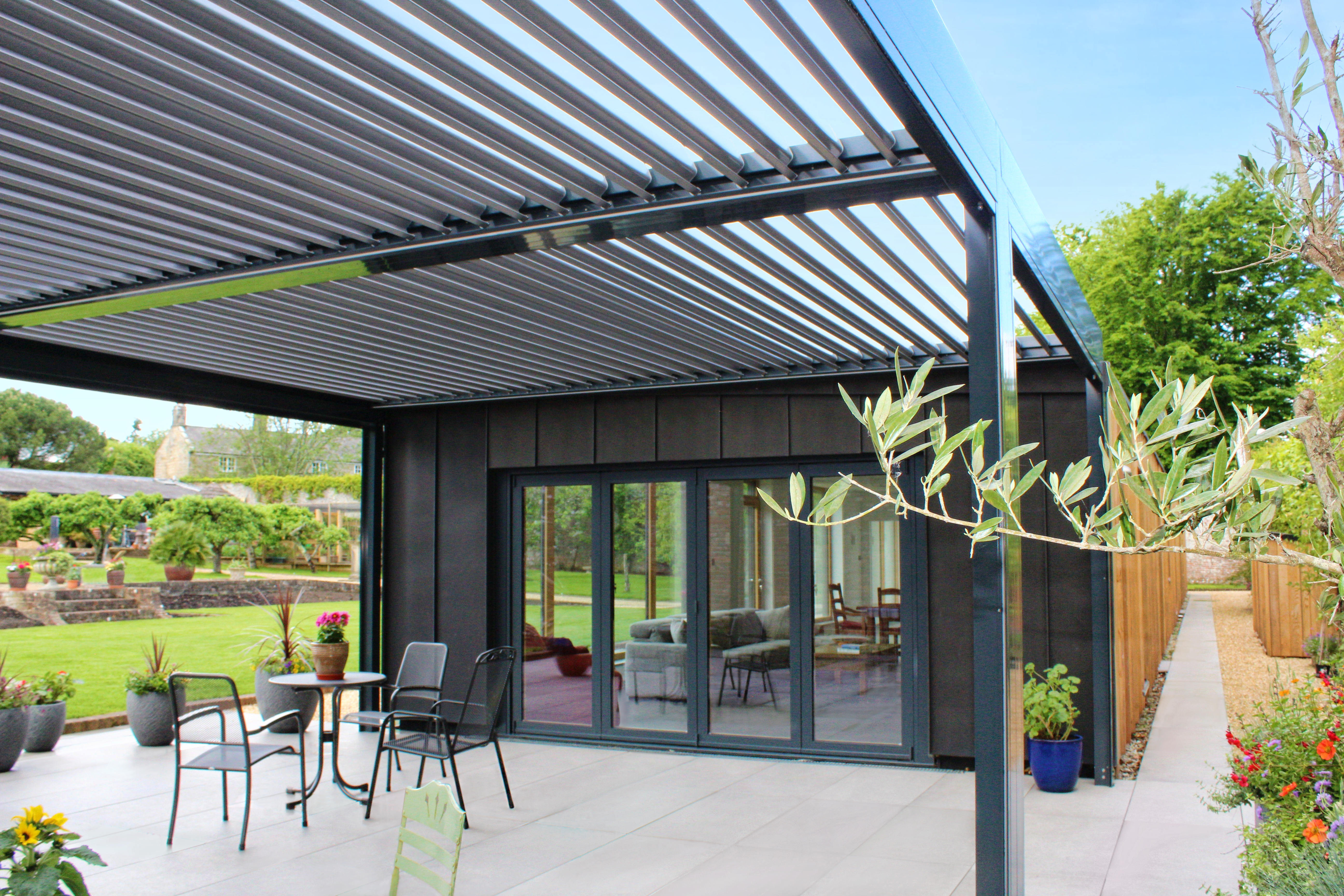 Custom-built pergola offering elegant sun protection in a rural Victorian walled garden setting