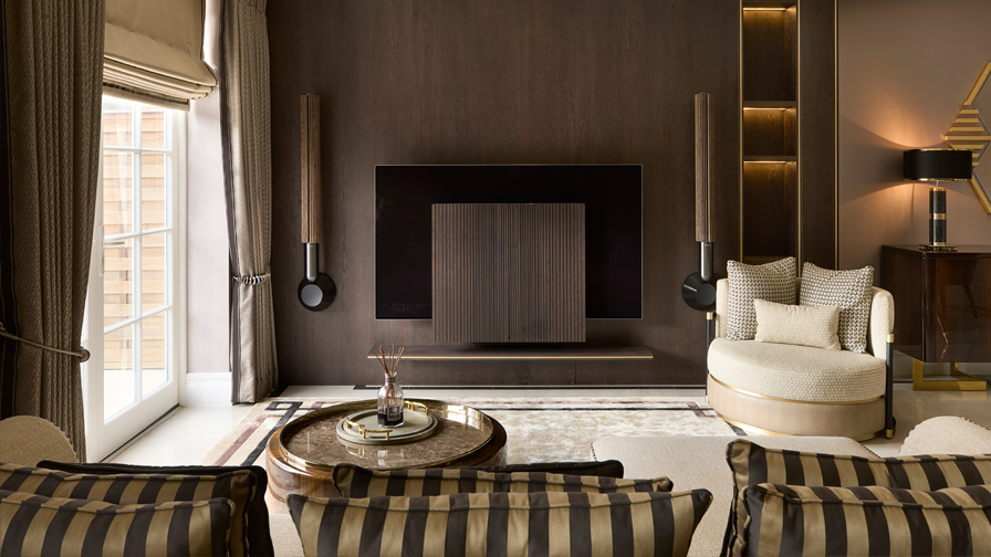 High-end luxury living room with bespoke interior design, featuring rich wood finishes, gold detailing, and sophisticated modern furniture layout.