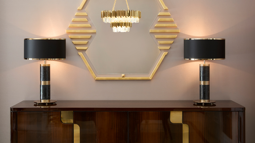 Elegant console area with dark high-gloss sideboard, gold-accented octagonal mirror, matching black and gold table lamps, and a crystal chandelier in a luxury interior design setting