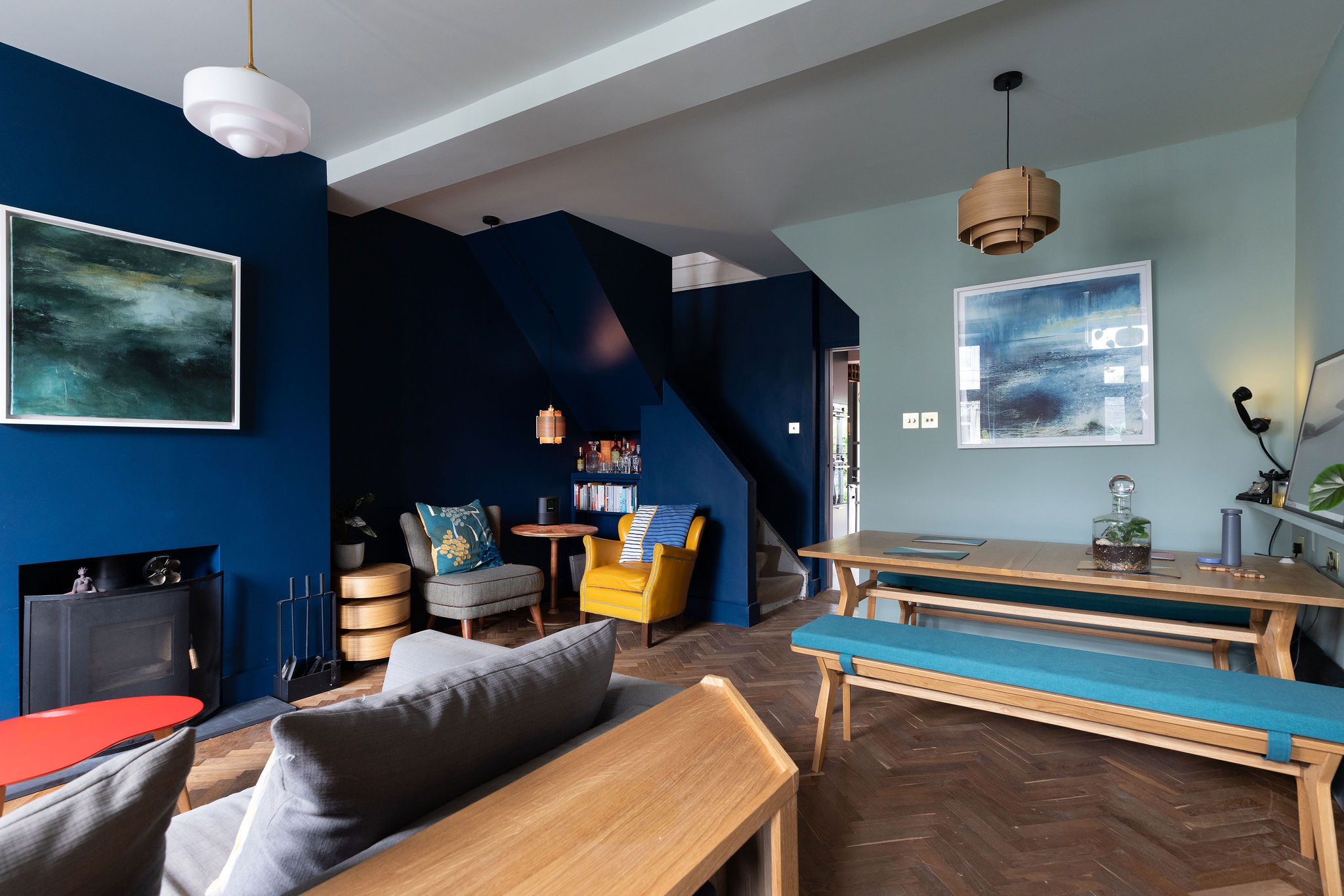 Lounge/dining room with rich colours and wooden furniture