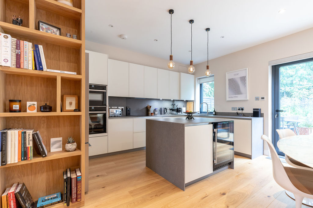 Bespoke joinery meets white minimalist kitchen with island
