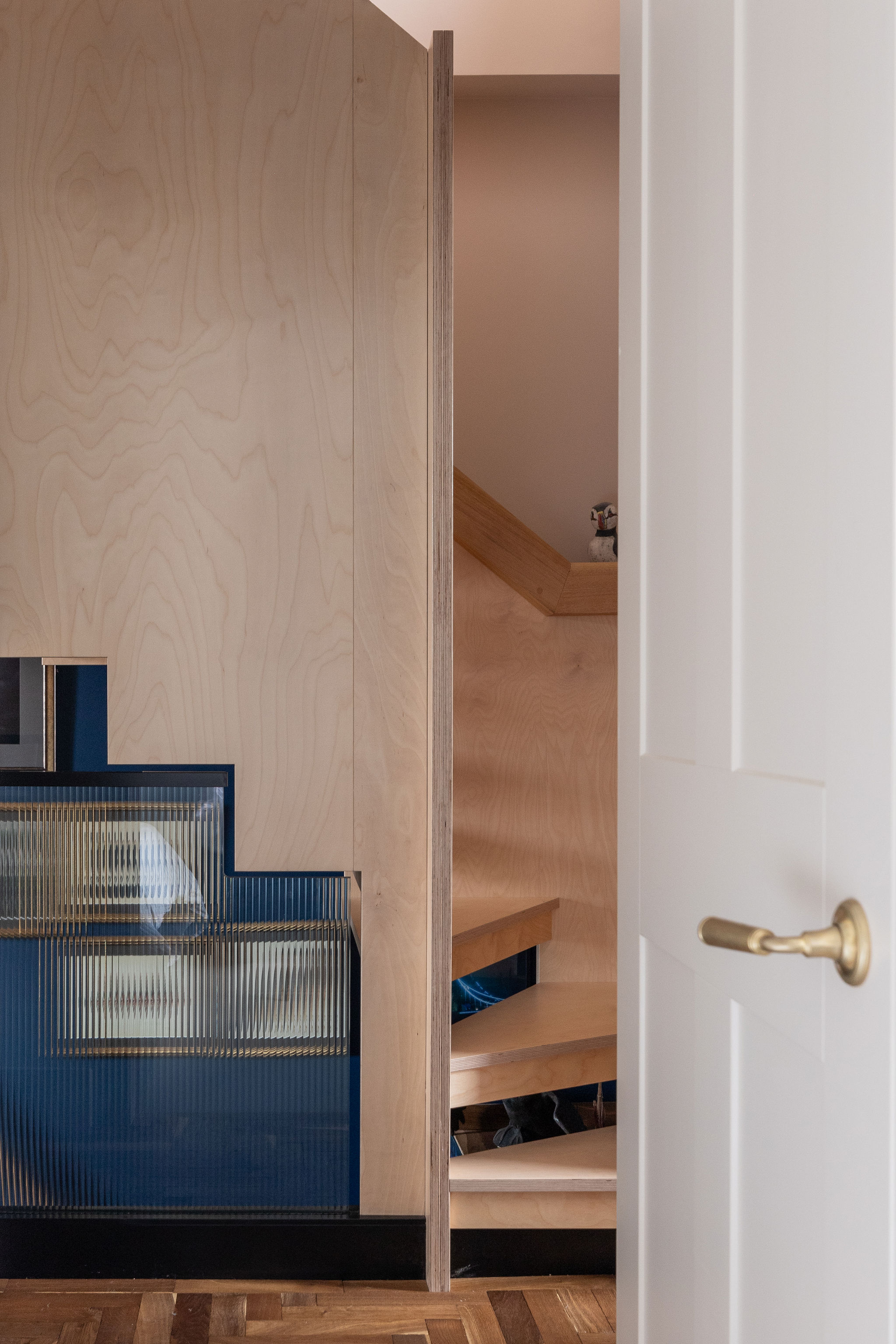 beautiful bespoke ply wood stairs with bevelled glass