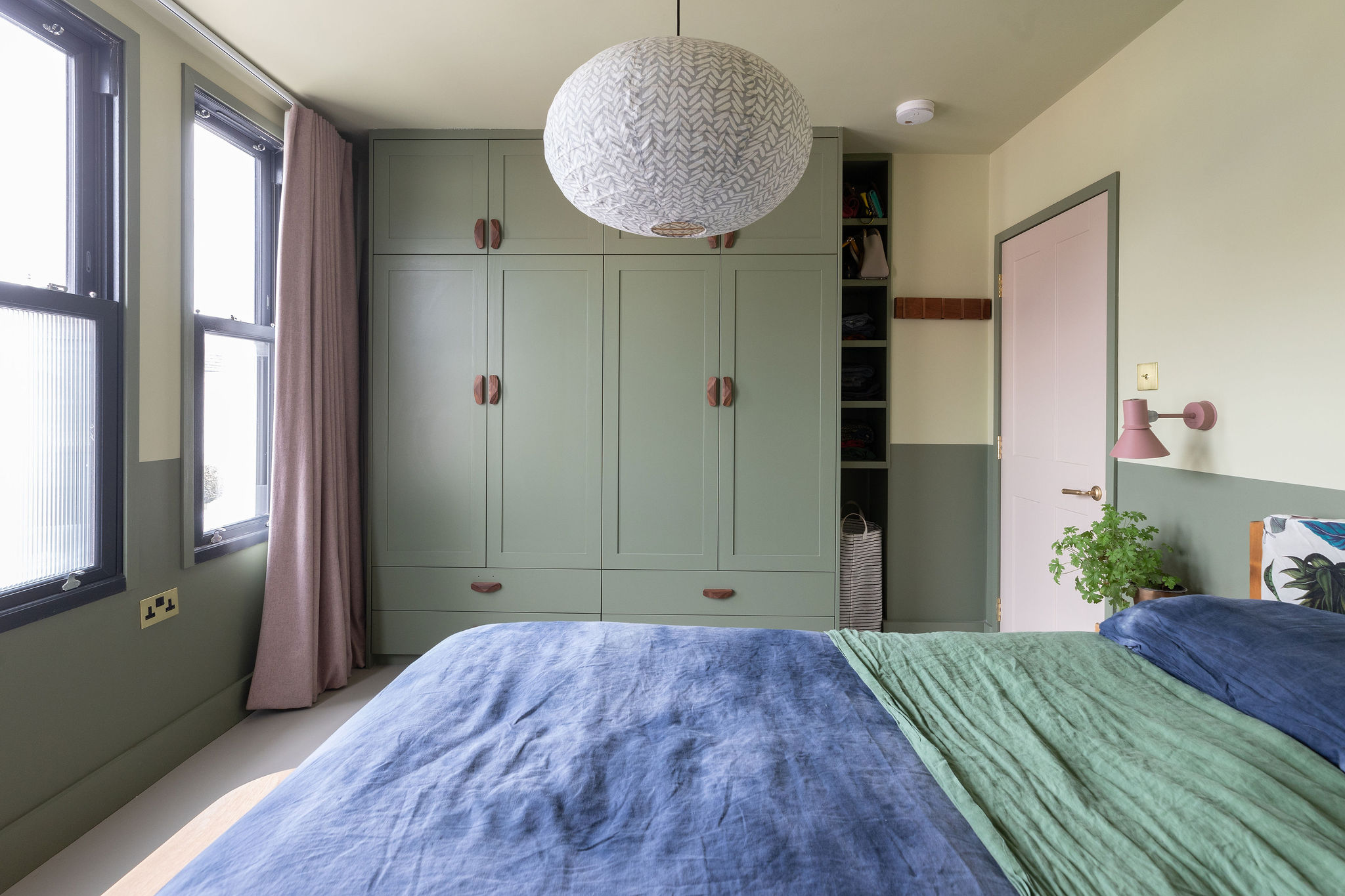 Beautiful bedroom with built in joinery painted green 