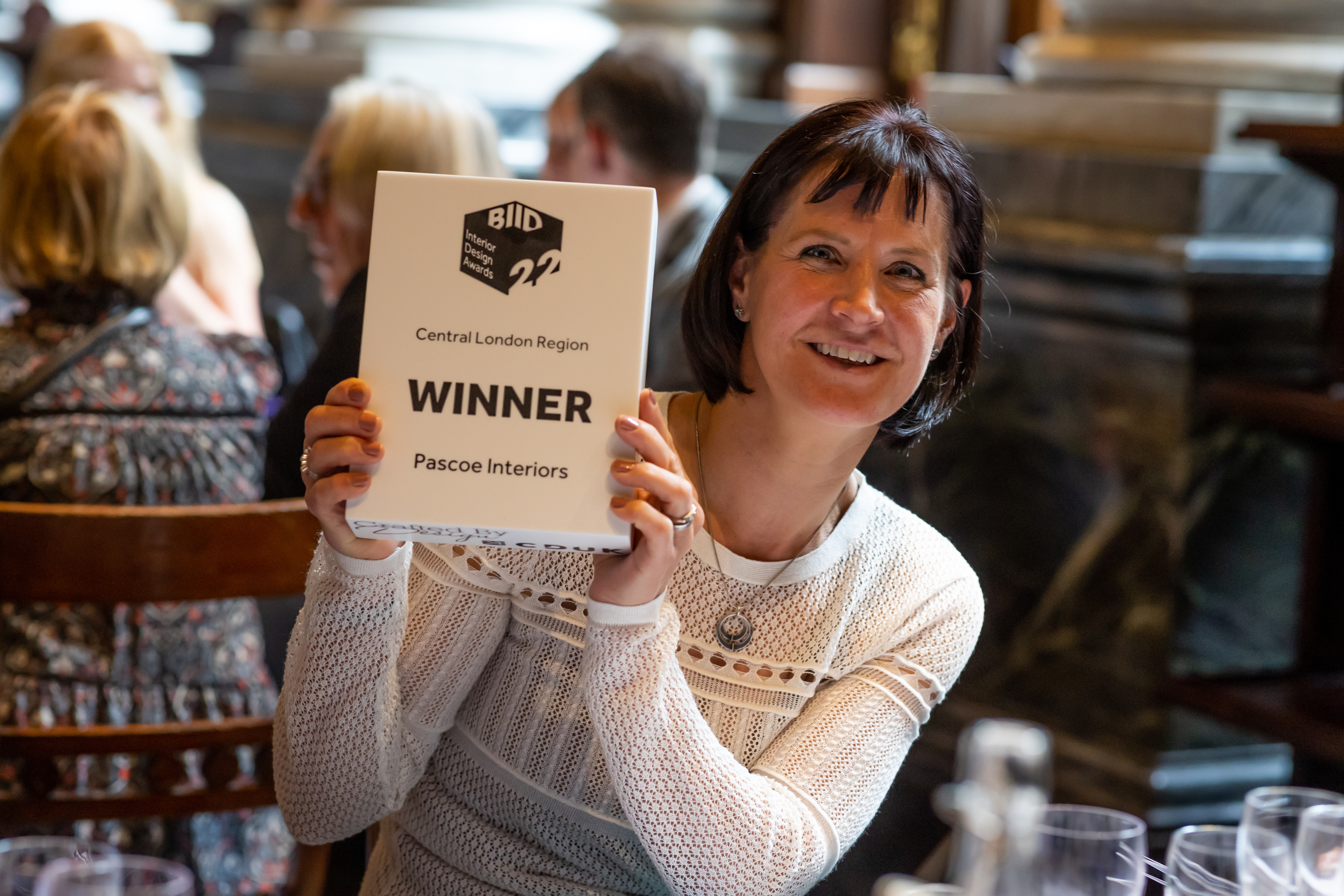 Winner holding their award