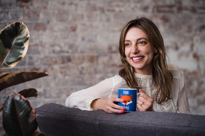 smiling woman holding a mug