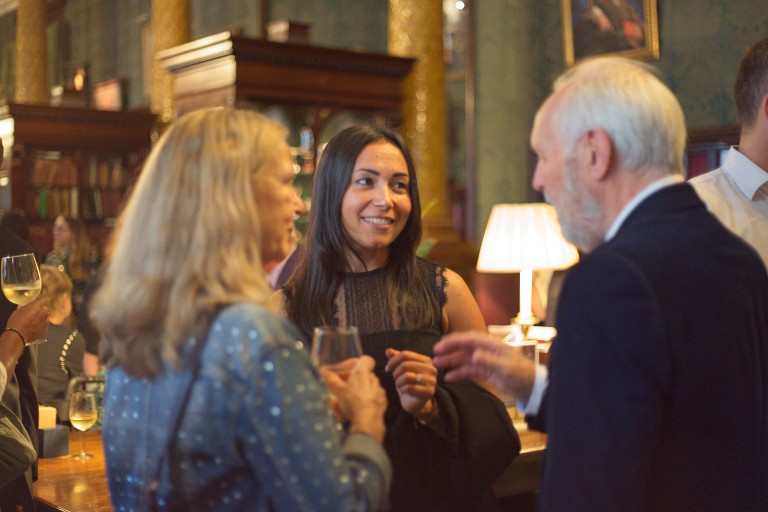 People speaking at drinks reception