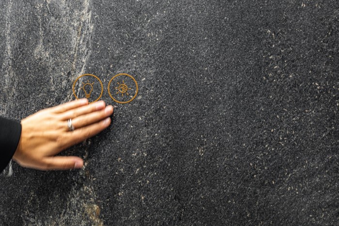 hand showing hypertouch on a wall