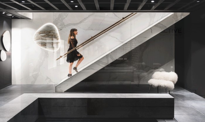 woman in a black dress walking up stairs