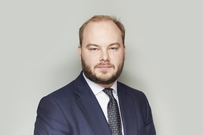 bearded man in a suit.