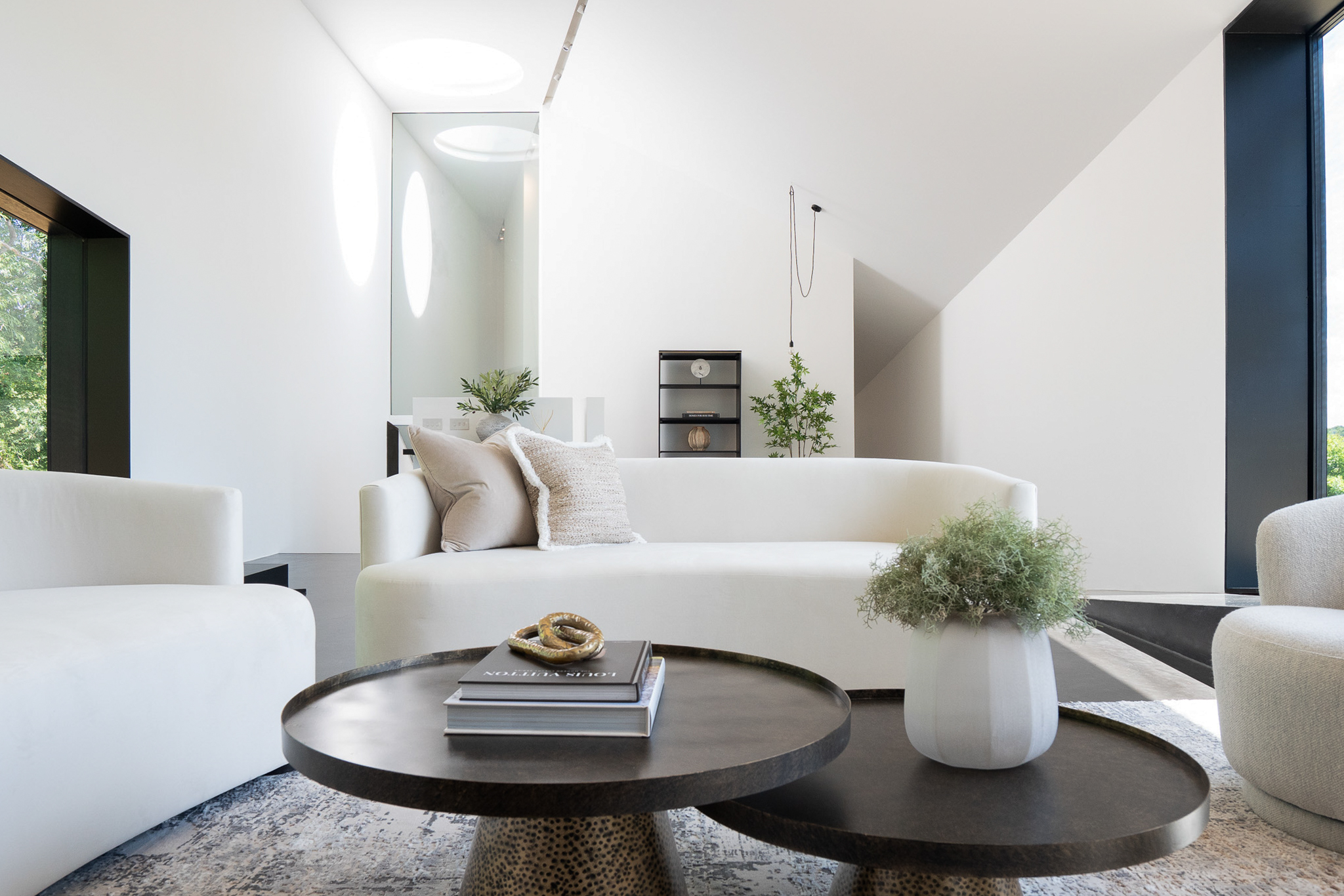 Neutral family room with curved sofas and coffee tables, designed by Kings Interiors Ltd in Berkshire.