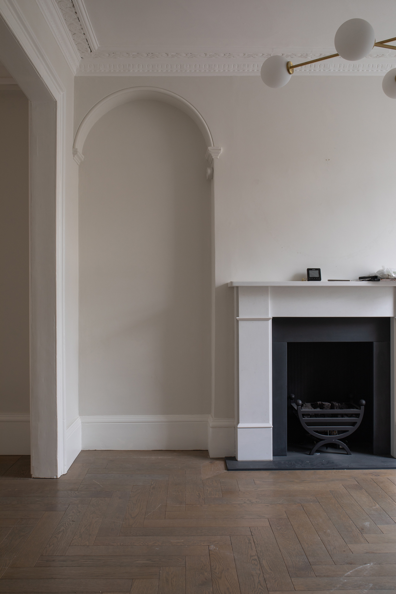 Interior architectural detailing within a Chelsea townhouse, showing early-stage refurbishment with restored period features as part of a full-service luxury residential renovation.