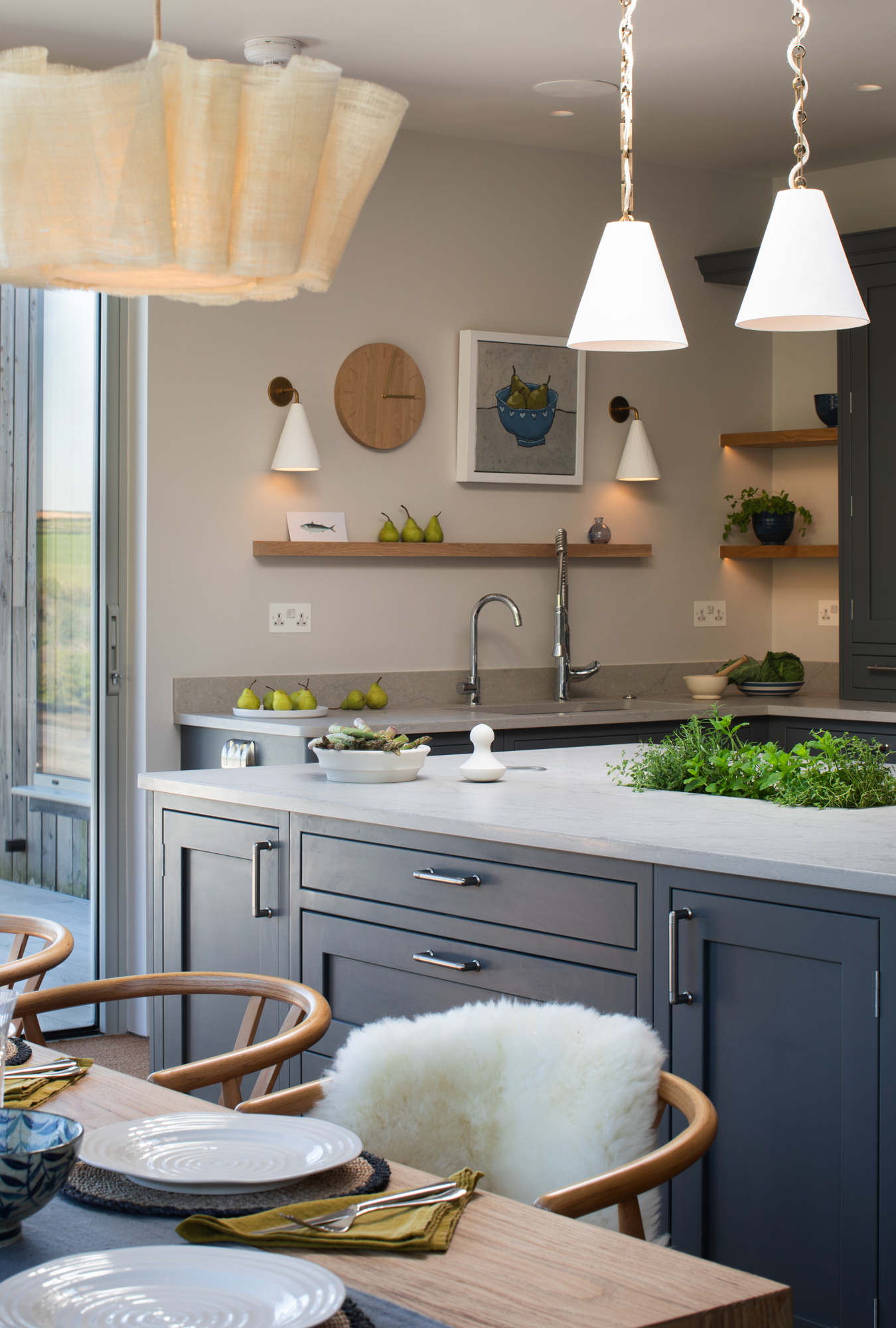 Contemporary kitchen and dining area within a riverside new build, fully designed, furnished and detailed as part of a high-end, turnkey interior architecture project.