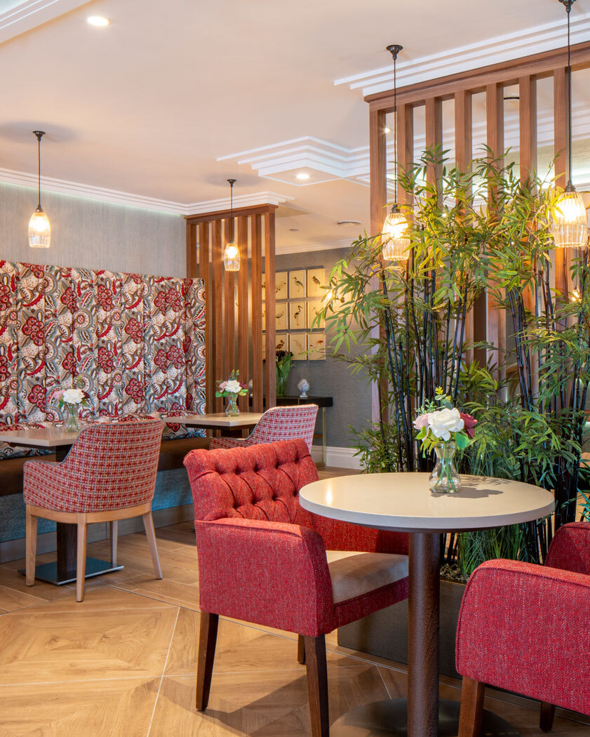 Dining area with fabric seats and wallpaper