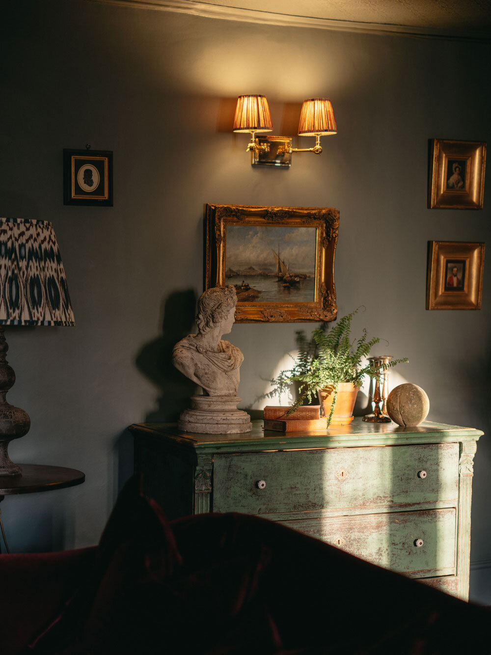 Chest of drawers and lighting on the wall