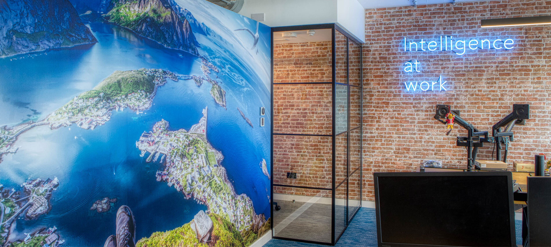 Office area with brick wall and neon sign