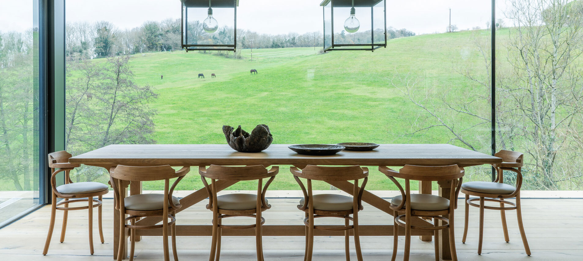 Dining table overlooking view with horses in field