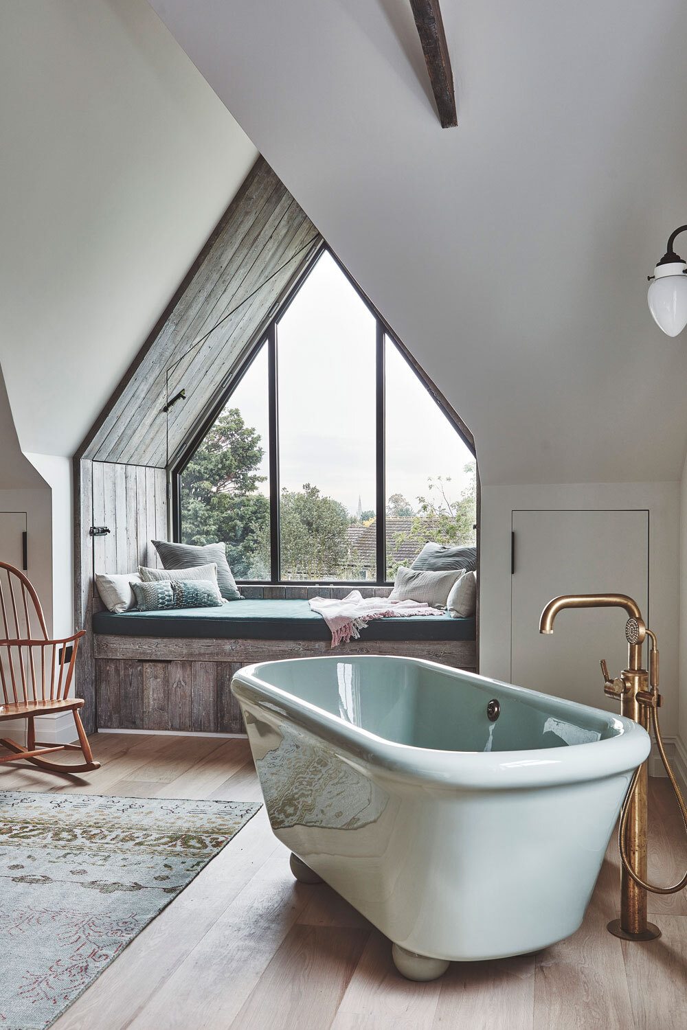 Freestanding bath infront of large window