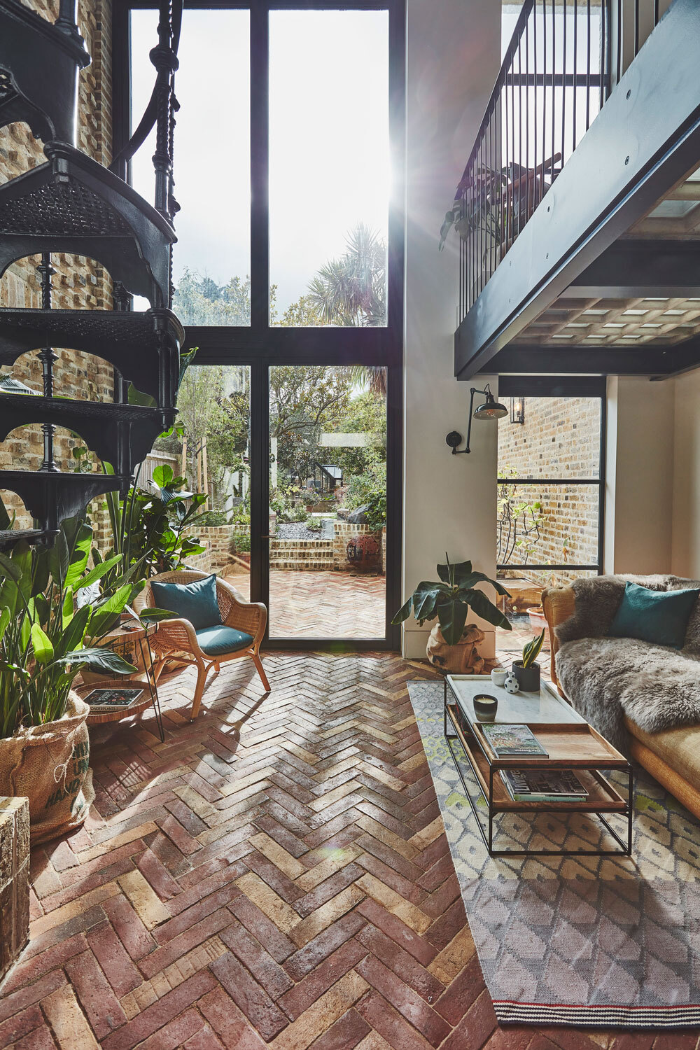 Wooden flooring in room with large windows and stairs