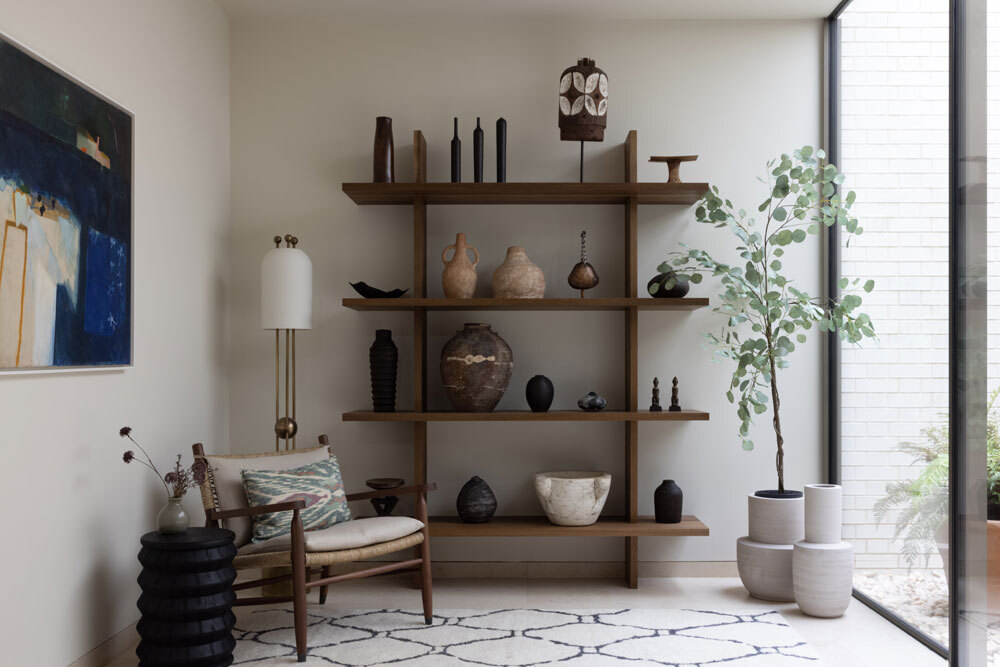 Chair infront of bookshelf and plant