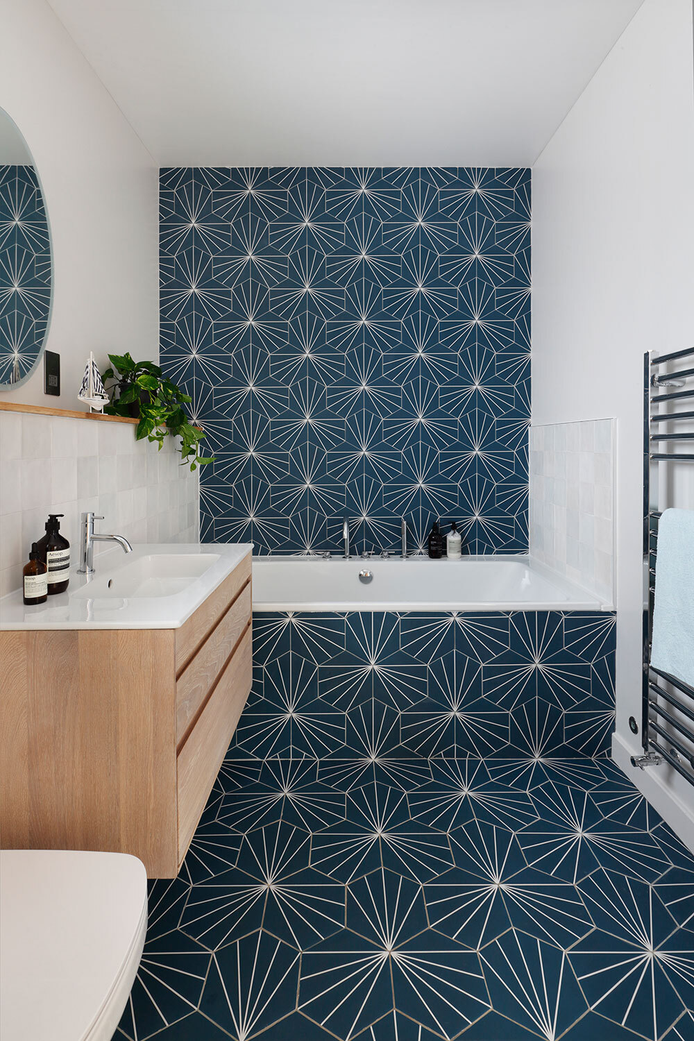 Tiled bathroom with bath