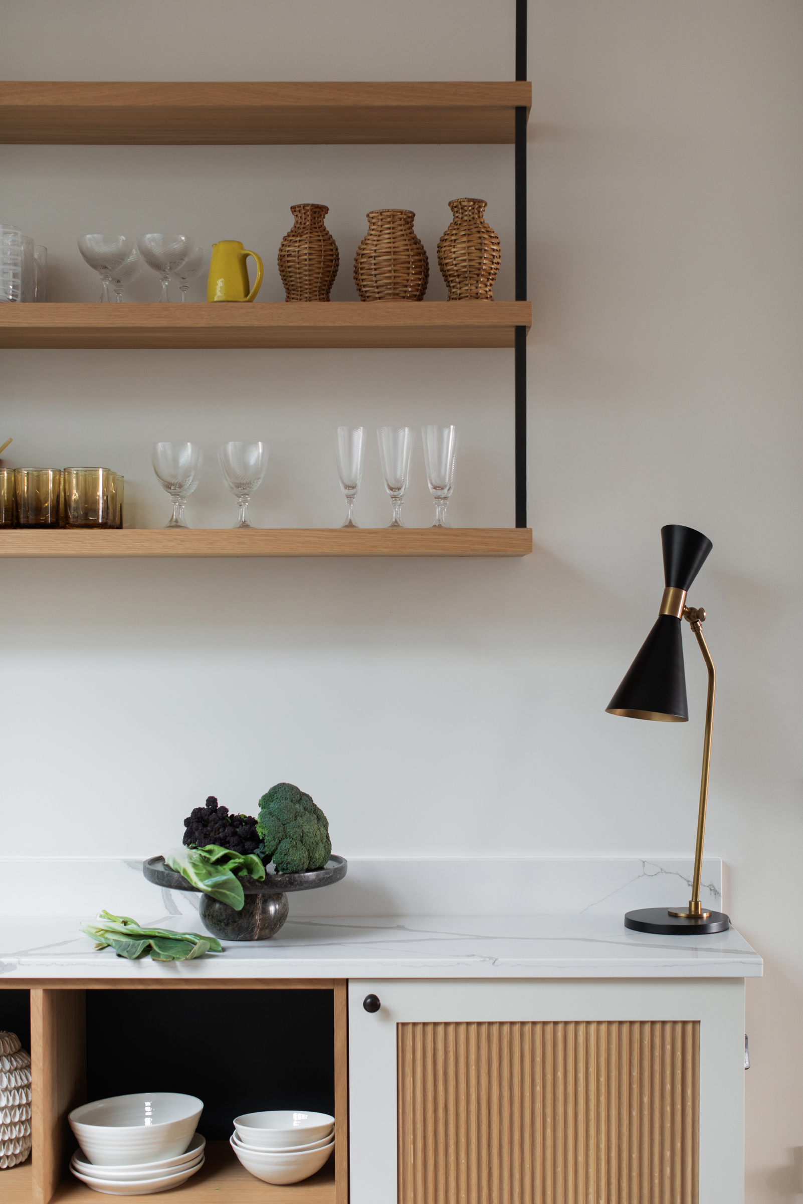 Kitchen detailing within a Victorian townhouse refurbishment, combining simple shelving, natural materials and contemporary interior architecture to support everyday family living.