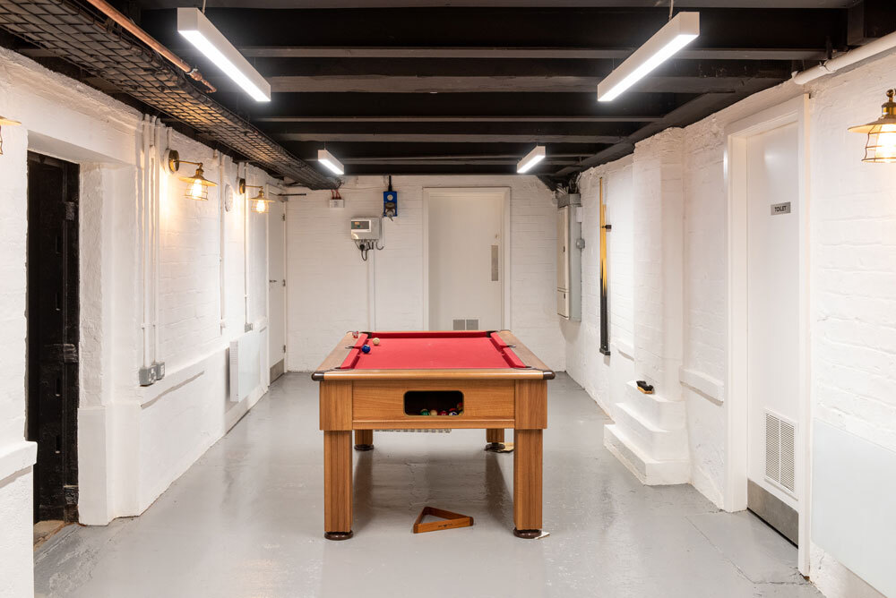 Pool table in the middle of room