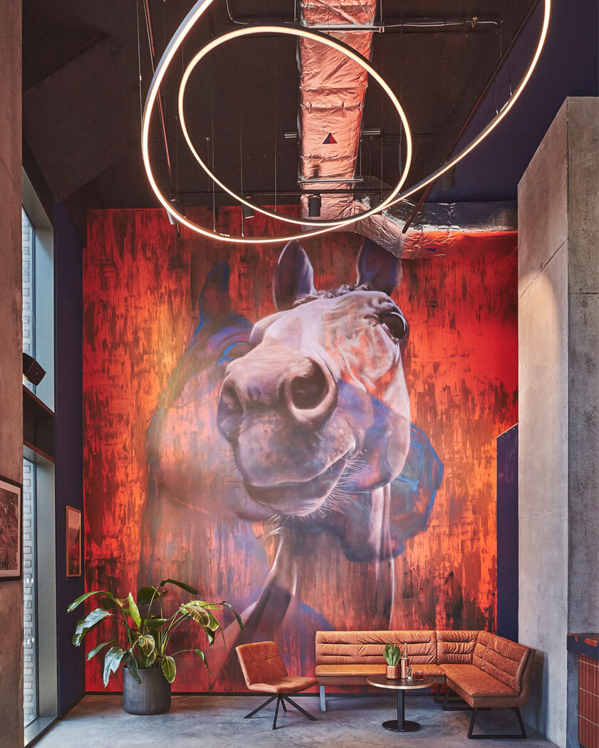 Tables with large horse image on wall