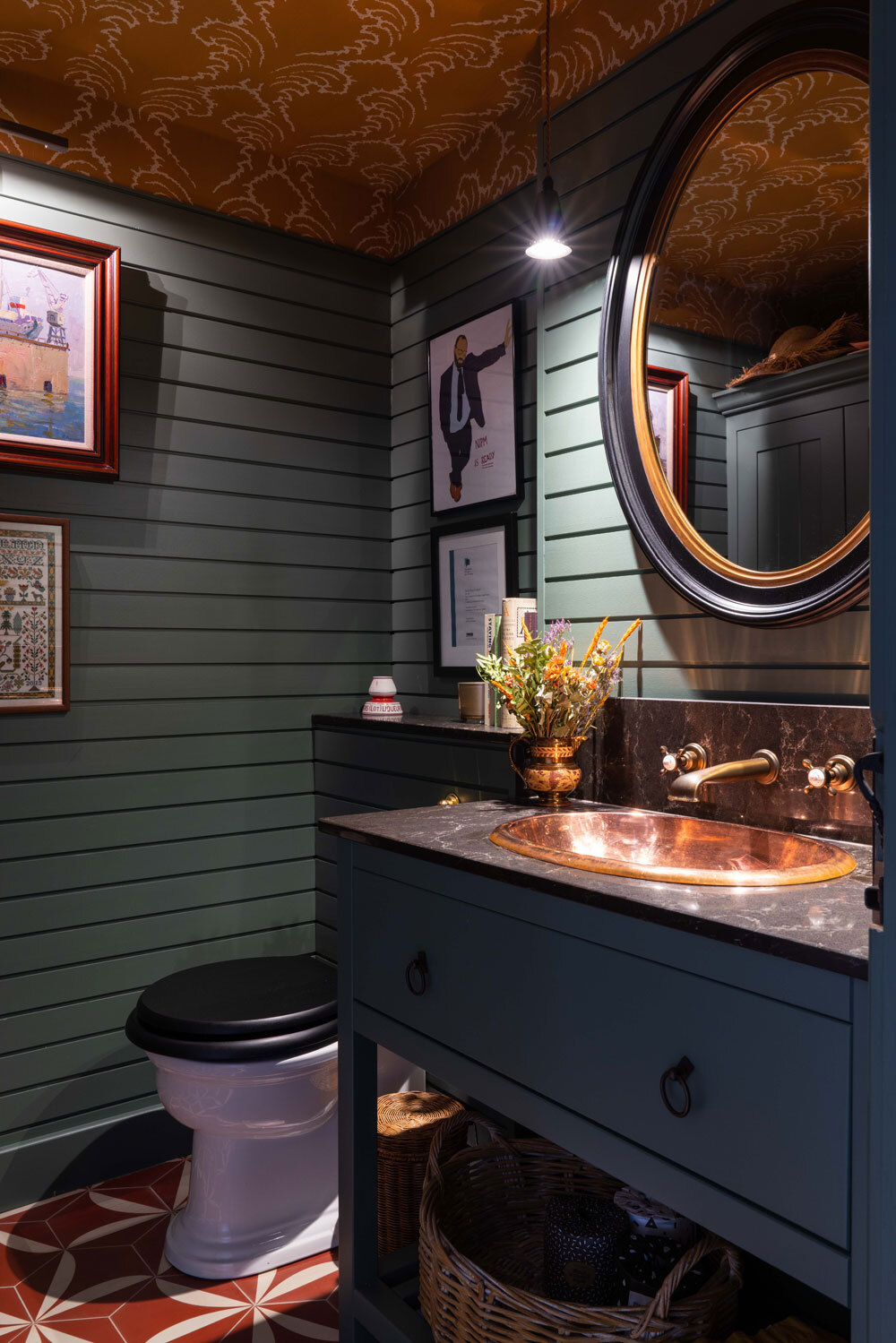 Bathroom sink and toilet with large oval mirror