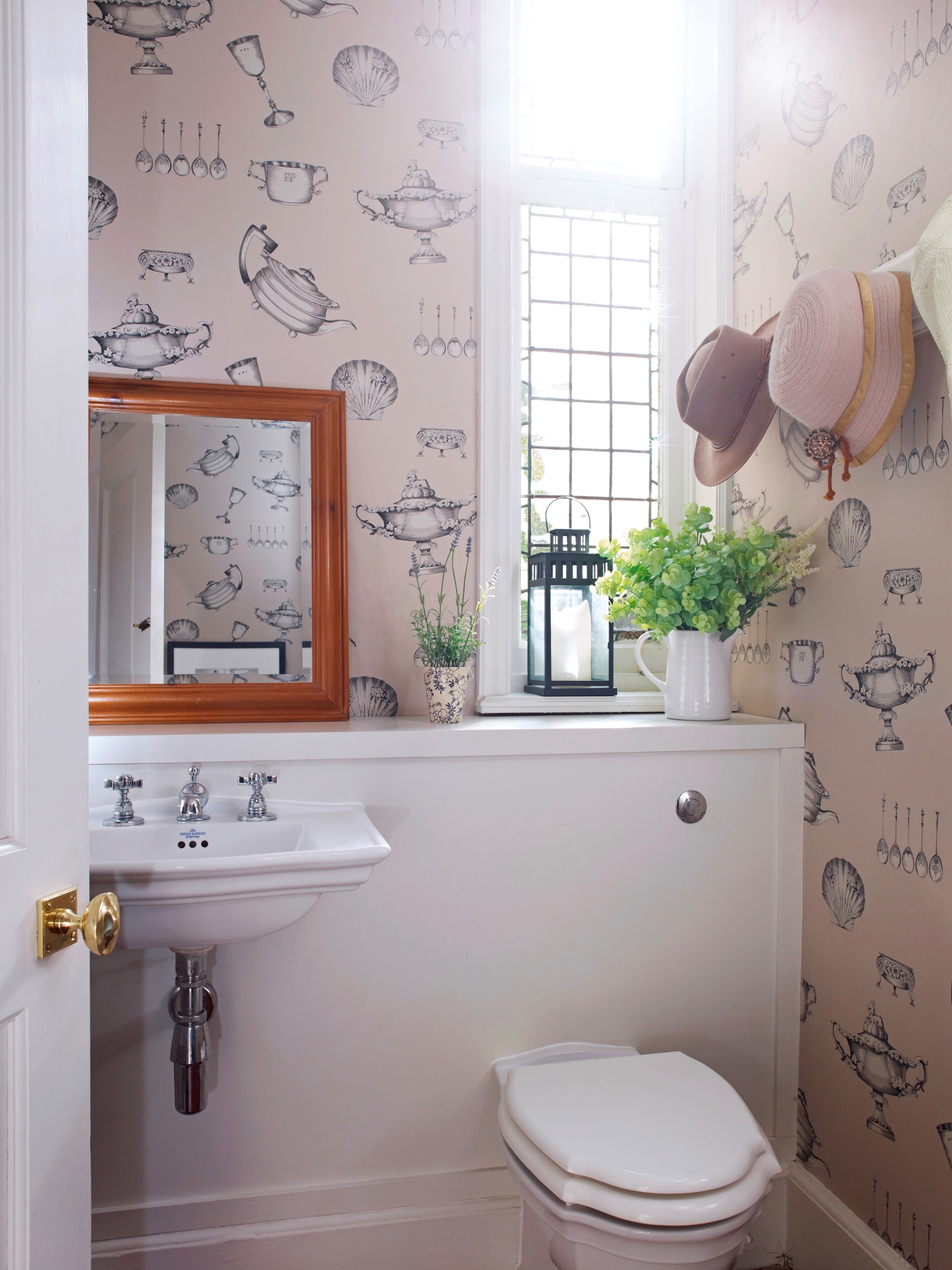 The family cloakroom off the hall was tidied, new fittings, heating & storage installed, & fun paper used as background for the hat display