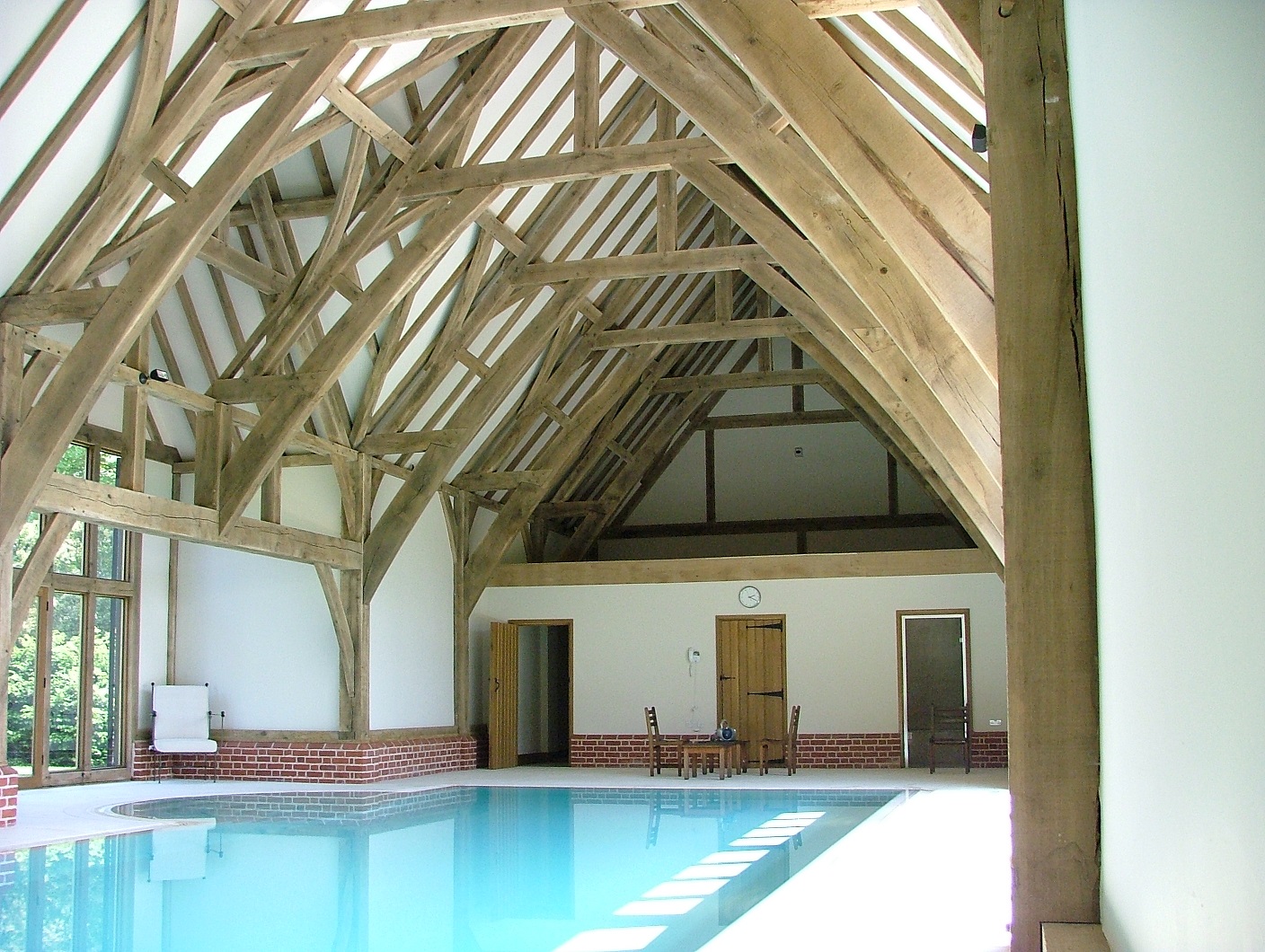 The pool house was designed in a barn-like building to match an adjacent barn, giving views front and back to the garden landscape