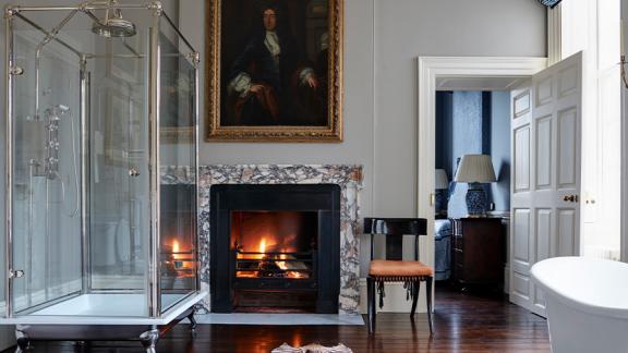 Fireplace with blazing fire in a bathroom